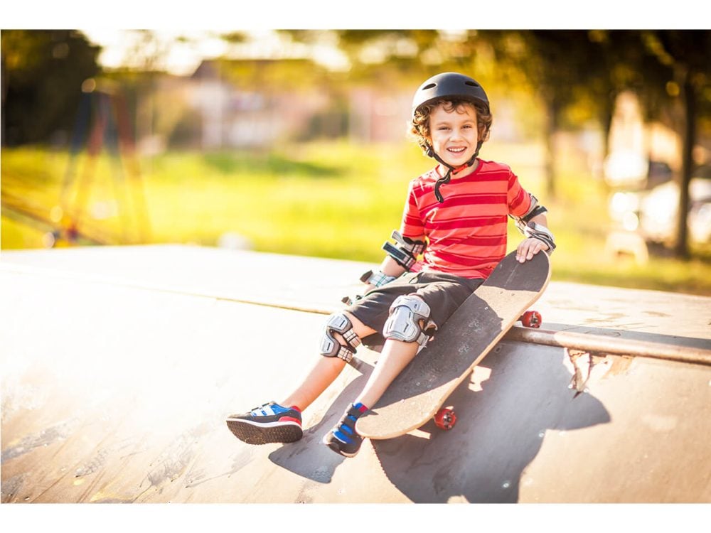Smiling child with skateboard